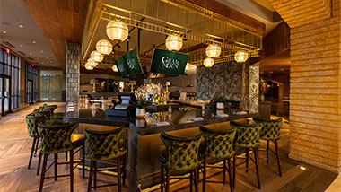 Bar in Gram & Dun with Green Chairs and Tvs