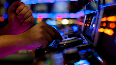hand pressing slot machine button